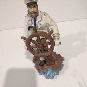 Captain Holding Onto Boat Wheel