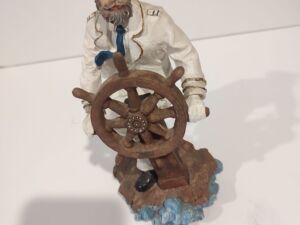 Captain Holding Onto Boat Wheel